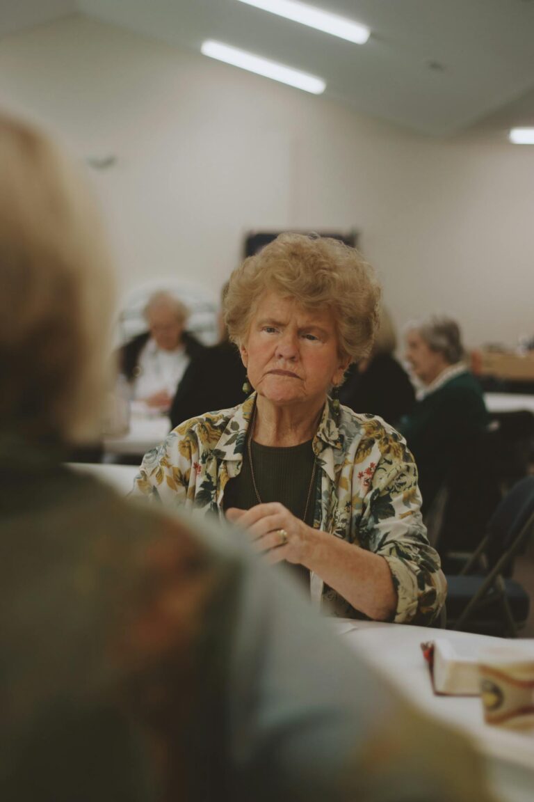 A diverse group engages in a Bible study, fostering community and spiritual growth indoors.