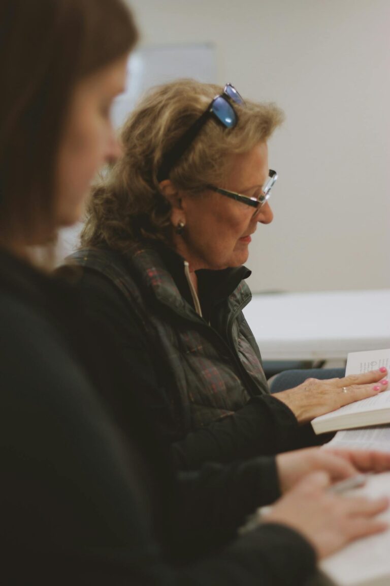 Women engaged in a Bible study group session indoors at a local church in Brevard, NC.